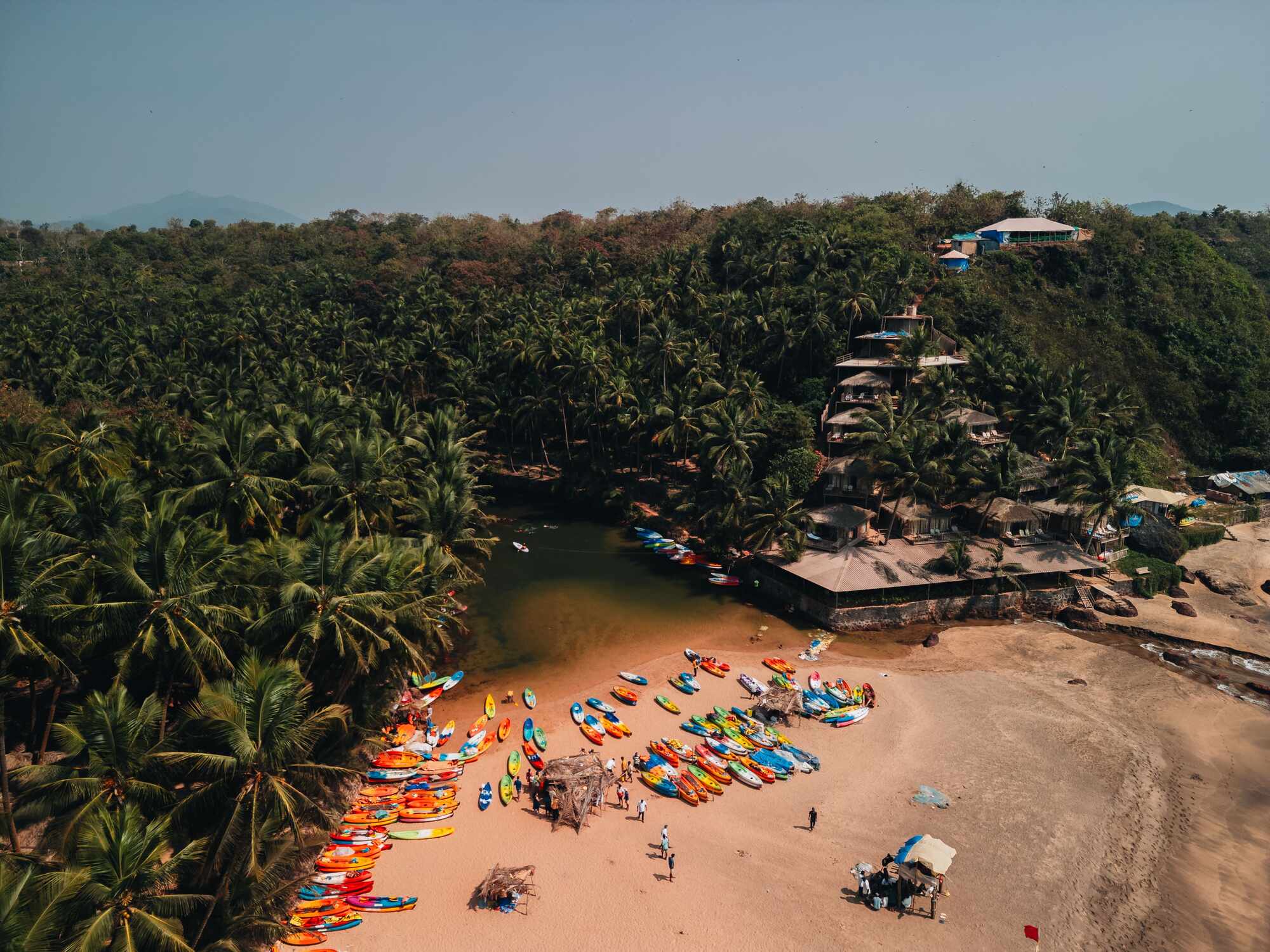 Aerial view of kayaks drawn up on the sand on a Goa beach